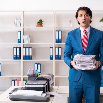 Man in suit not happy with all the faxes he needs to send